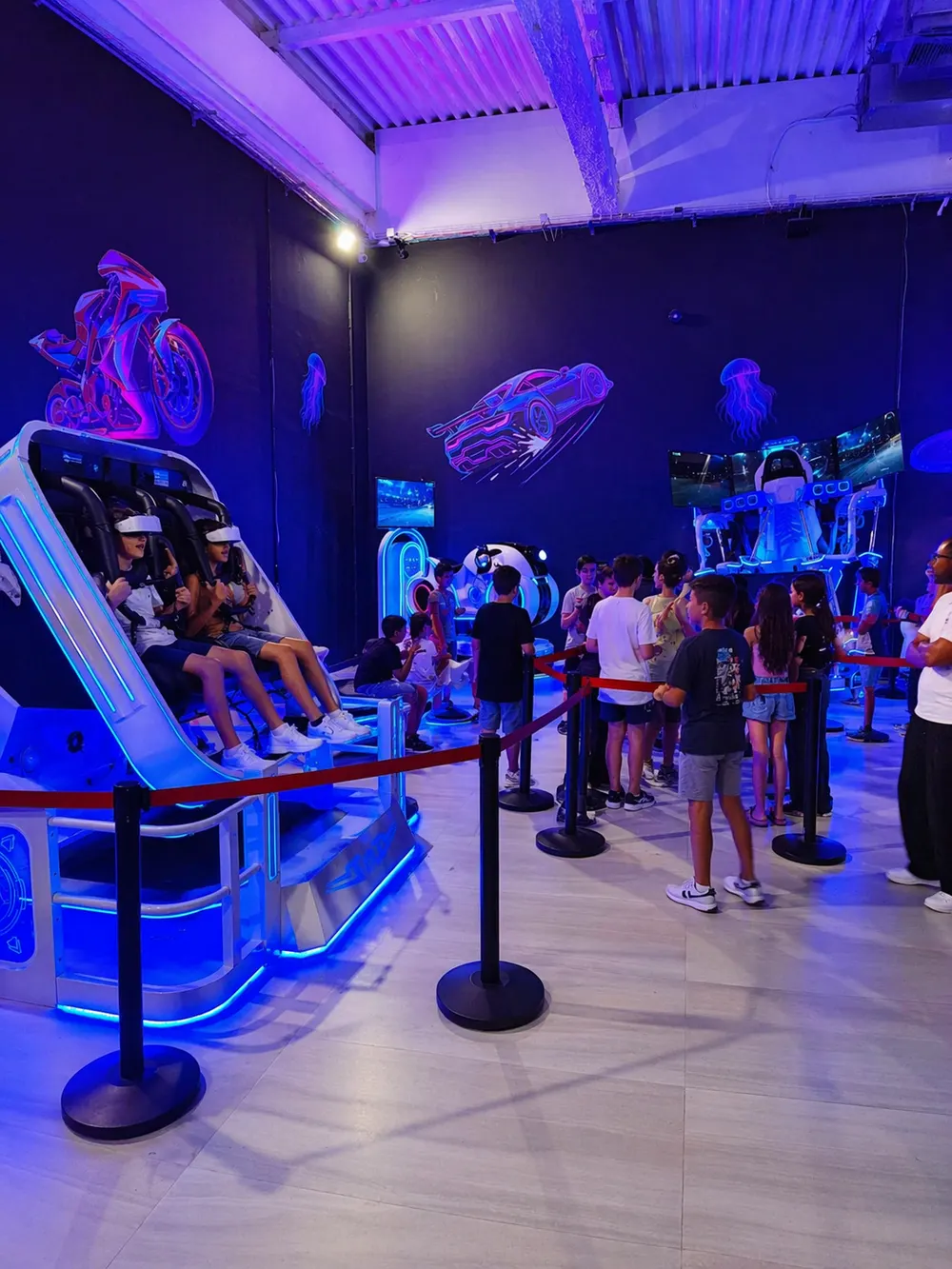 Kids at a VR simulator station and queue at the Space Run VR venue