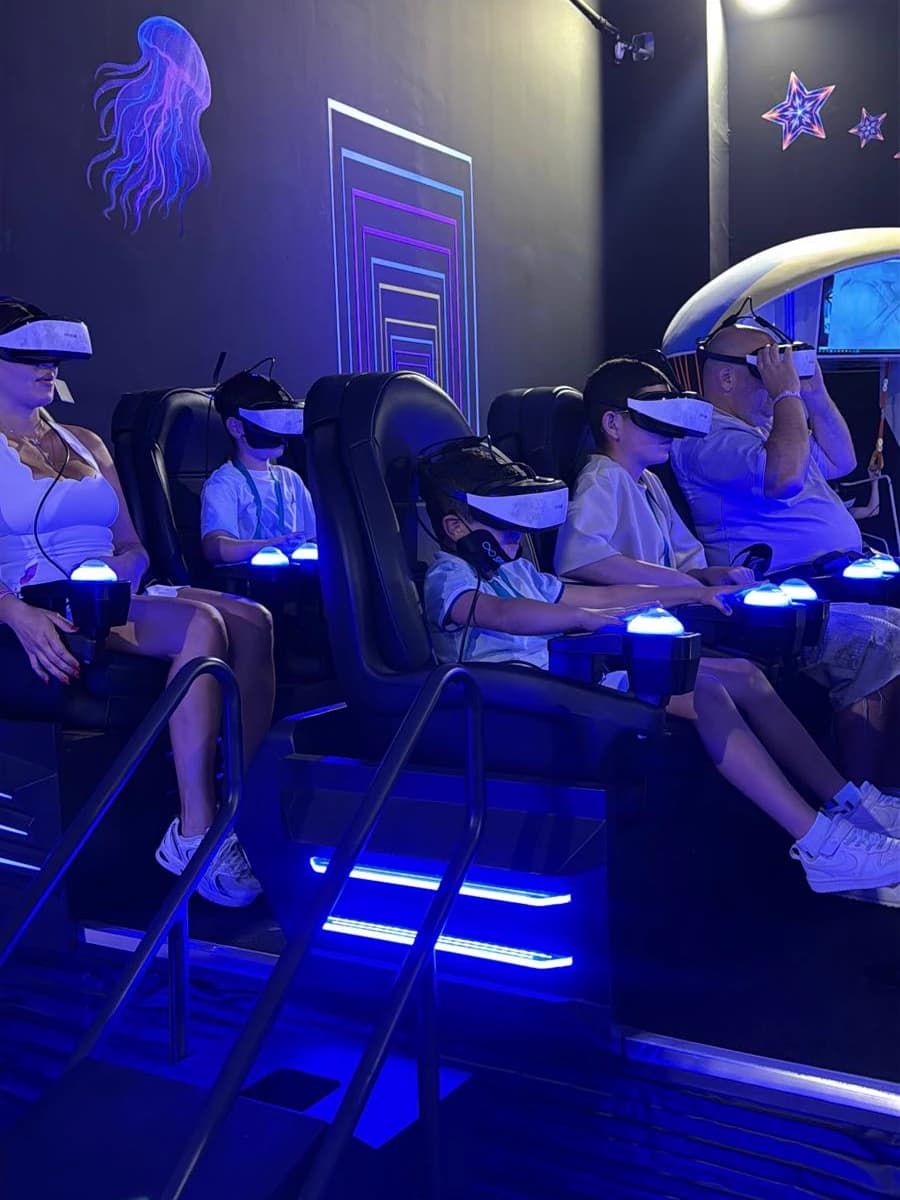 Adults and kids riding the VR6 together, wearing VR headsets