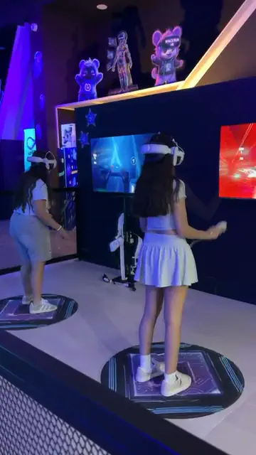 שתי שחקניות על במת Beat Saber, במבט מאחור