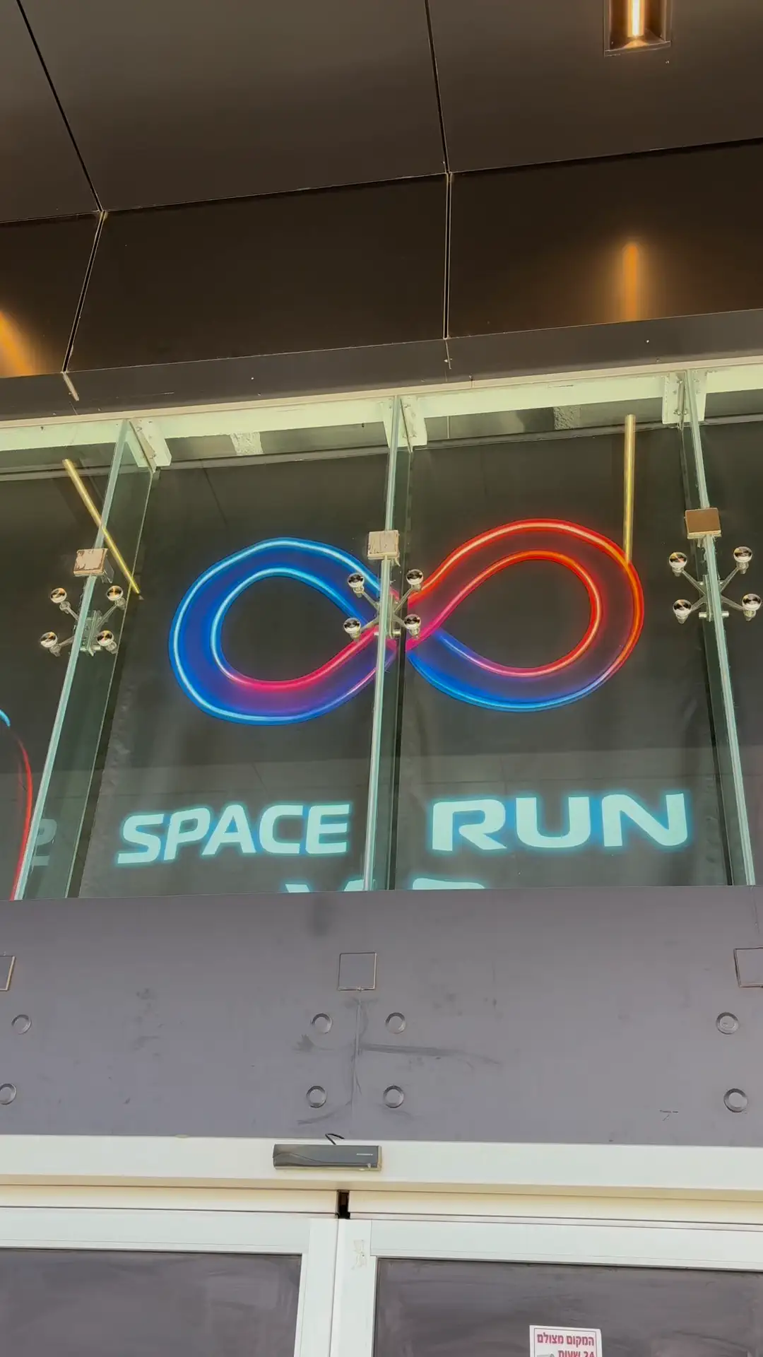 The Space Run VR neon sign above the glass entrance door